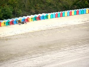 A view of the beach huts on Llanbedrog beach view from the Wales Coastal Path Llyn Peninsula North Wales