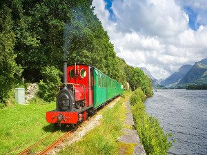 Image of the train running along Lake Padarn Llyn Padarn railway North Wales train trip