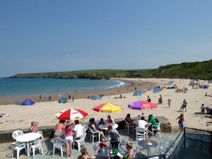 People eating and drinking outside the cafe at Porthor Porth Oer Whistling Sands Llyn Peninsula