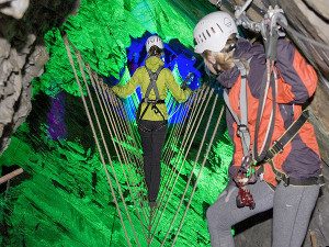 People on a rope bridge in the Zip World Caverns underground adventure North Wales