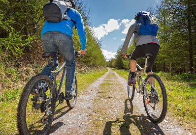 Couple cycling in the countryside North Wales