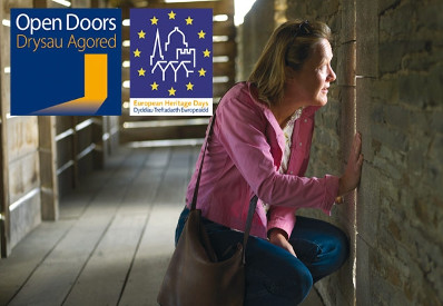 Lady looking through window at a Cadw Open Doors location.