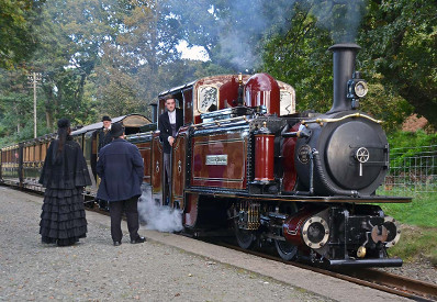 A waiting steam train at Ffestiniog Railway, Porthmadog. Passengers dressed in Victorian costume