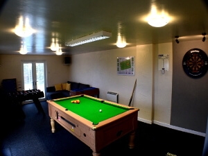 Image of Gors-lŵyd games room with pool table, dart board and foosball table