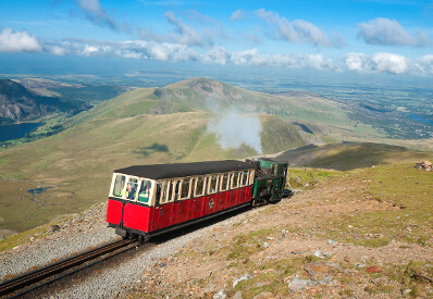 Snowdon Mountain Railway steam train approaching the summit of Snowdon Yr Wyddfa