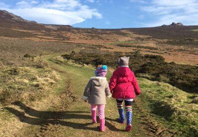 young girls walking up a mountain hand in hand